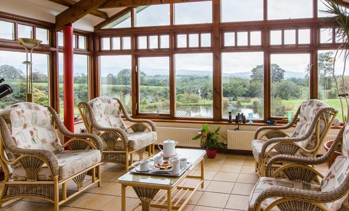The conservatory set for a welcome afternoon tea.